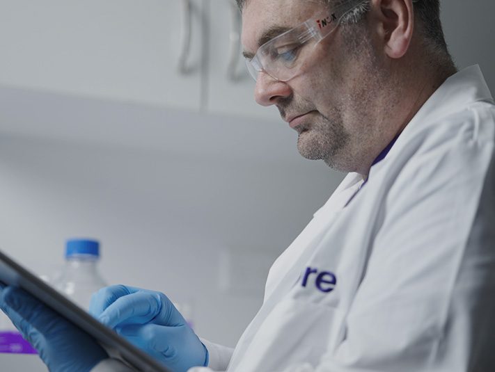 Sabre chemist with white gown during working process